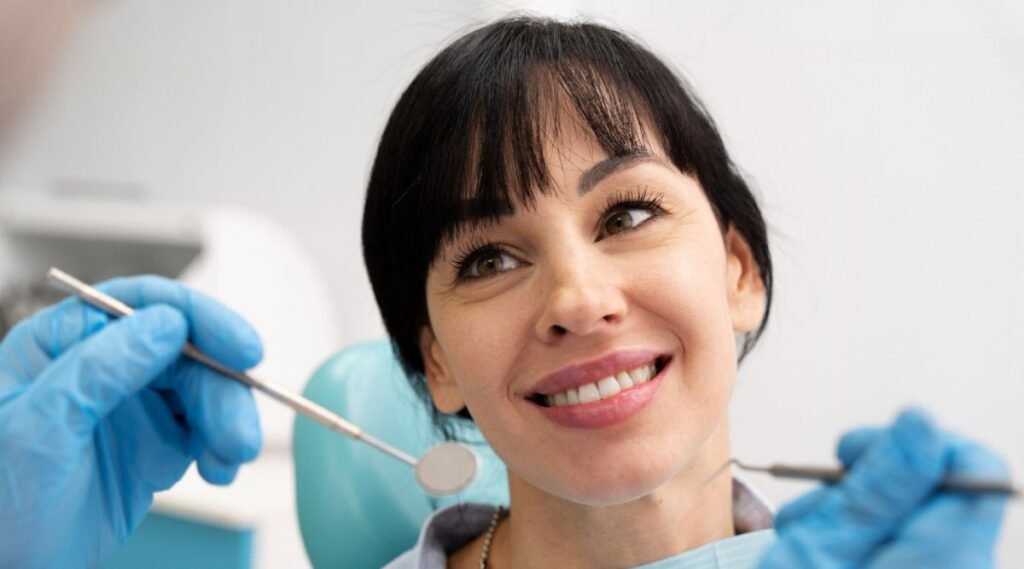 A dentist performing a check-up on a patient, discussing the cost of a smile makeover in India.