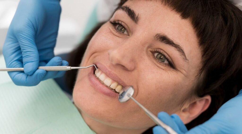 A female patient undergoing a procedure at the dentist's office, with the dentist explaining the cost of a smile makeover in India.