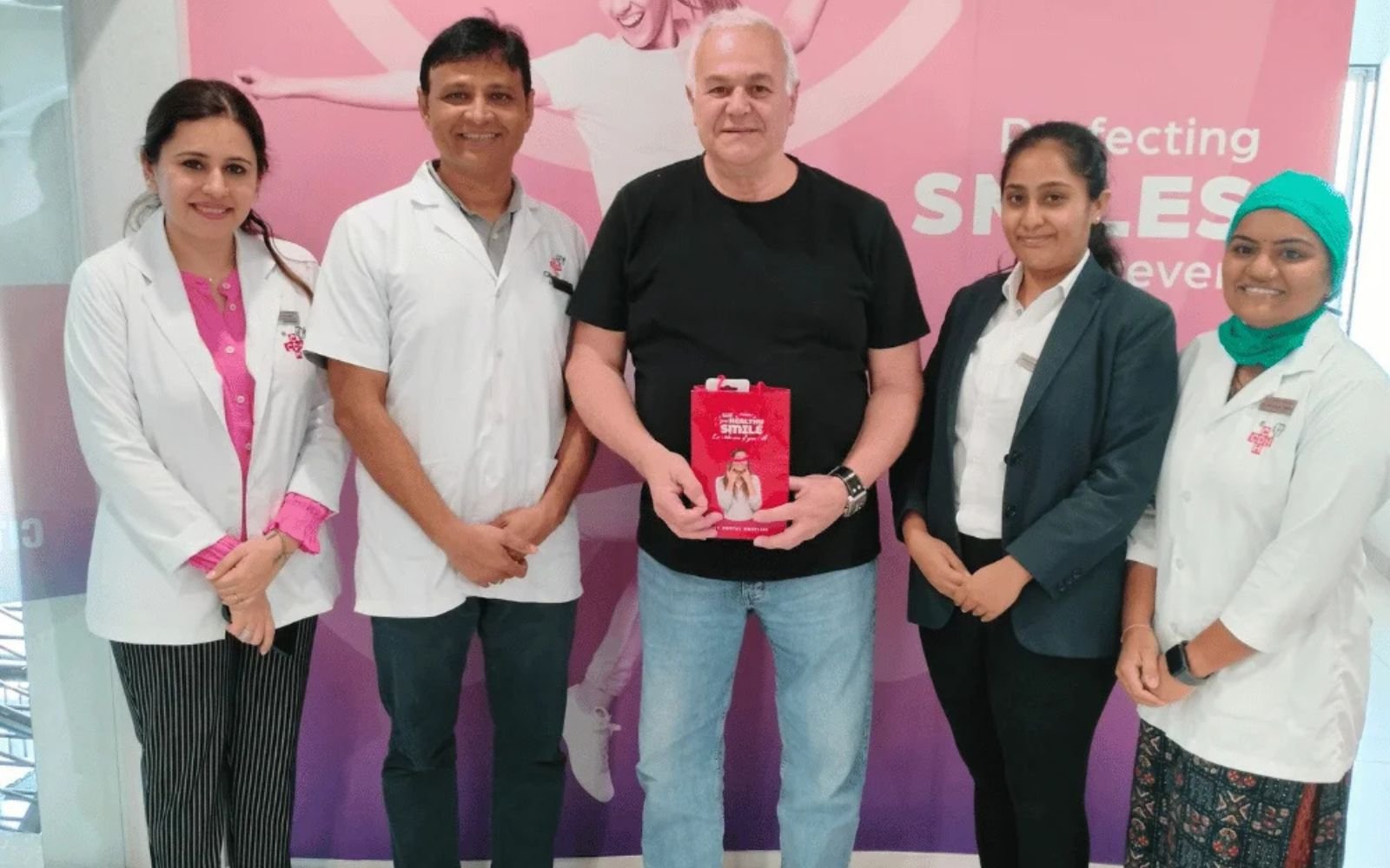 A happy international patient with the dental experts at City Dental Hospital, India – promoting dental tourism in India with world-class smile makeover treatments.